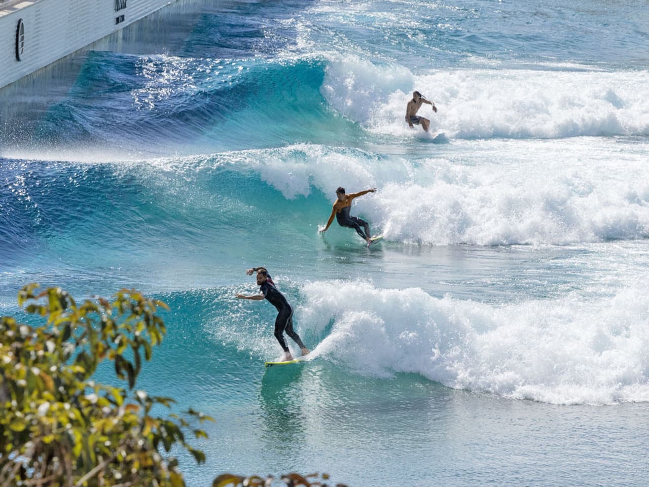 Surfers riding the Zion Shores lagoon