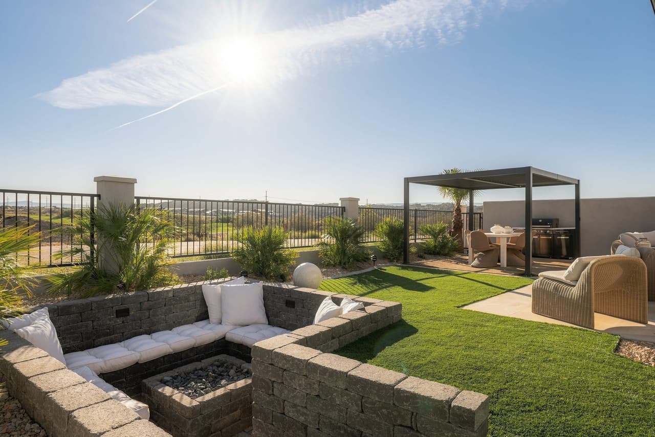 Fire-pit lounge, lawn, and pergola dining in the Zephyr House backyard