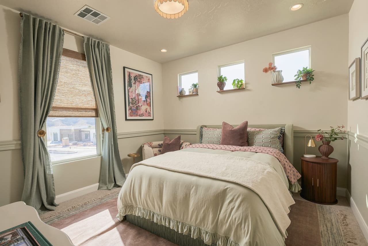 Powder Room Suite at Zephyr House — pink and sage bedroom with floral art and clerestory light