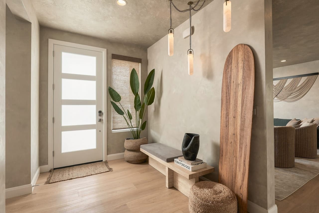 Zephyr House entry styled with a Tom Ford book, surfboard art, and bird of paradise
