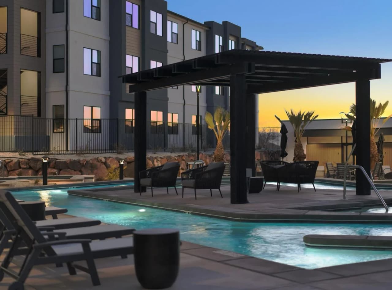 Sunset over the pool and palm-lined deck at the Terra community