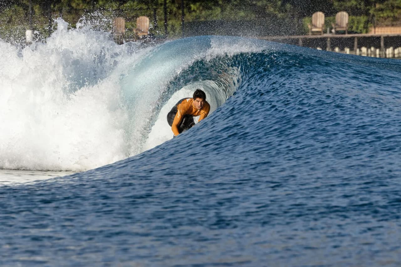Surfer riding a barrel wave in the Zion Shores surf lagoon
