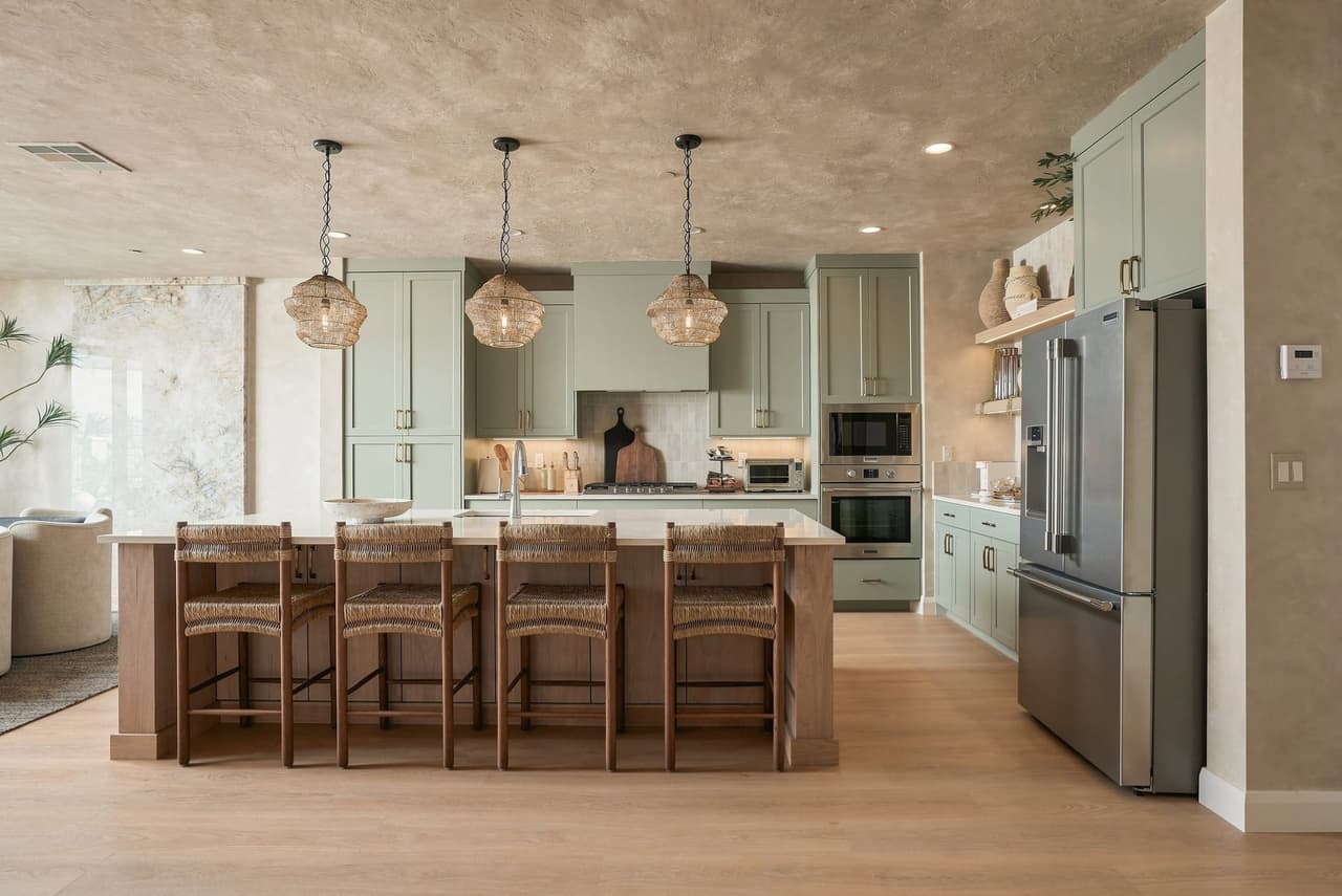 Sage kitchen and island at Zephyr House — the finished home owners hand off